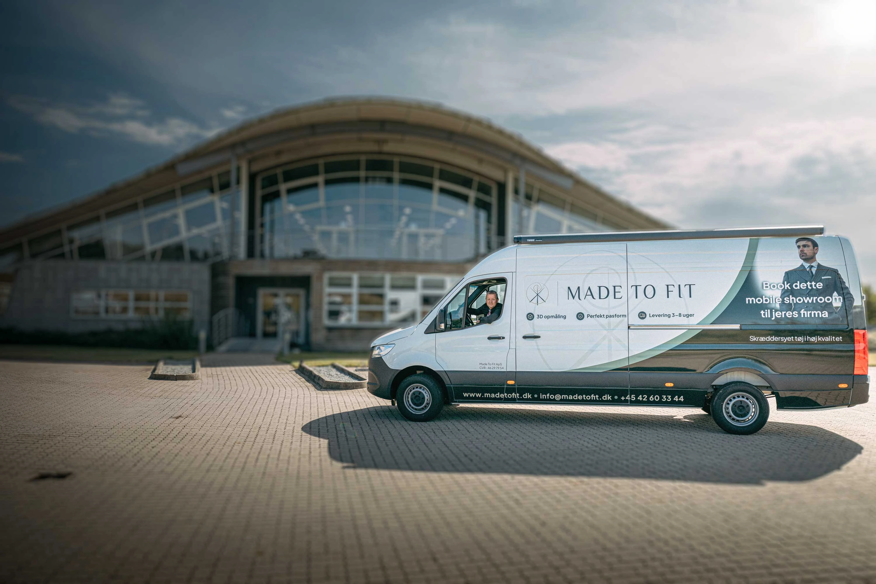 Made To Fit's mobile showroom – varevognen foran et kontorhus i Lisbjerg med en medarbejder i førersædet.